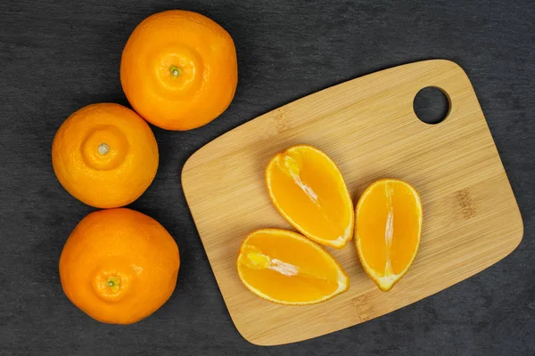 Orange minneola tangelo on grey stone — Stock Photo, Image