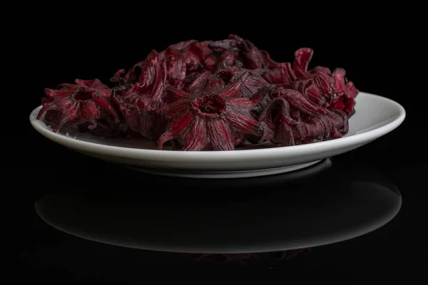 Candied hibiscus isolated on black glass — Stock Photo, Image