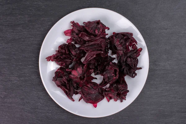 Candied hibiscus on grey stone — Stock Photo, Image