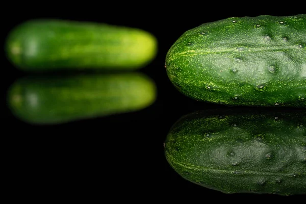 Frische grüne Gurke isoliert auf schwarzem Glas — Stockfoto