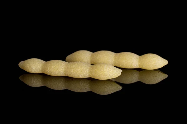 Raw cavatelli pasta isolated on black glass — Stock Photo, Image