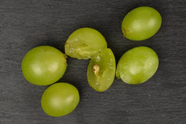 Green wine grape on grey stone — Stock Photo, Image