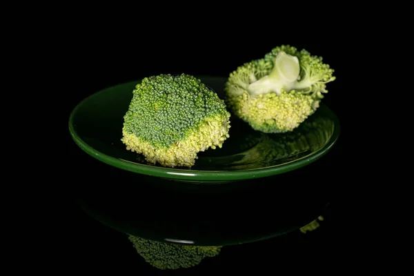 Fresh green broccoli isolated on black glass — Stock Photo, Image