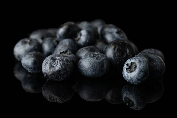 Fresh blueberry isolated on black glass — Stock Photo, Image