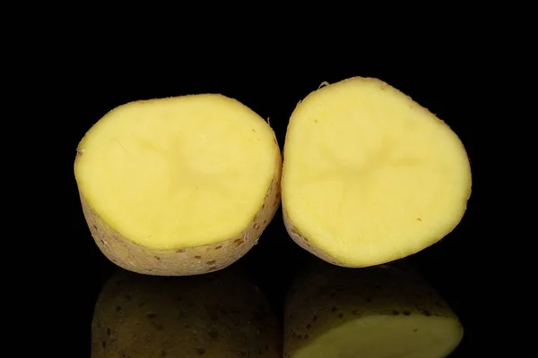 Raw brown potato isolated on black glass — Stock Photo, Image