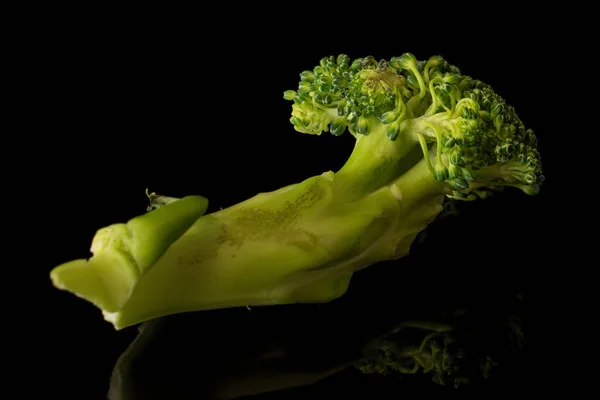 Fresh breen broccoli isolated on black glass — Stock Photo, Image