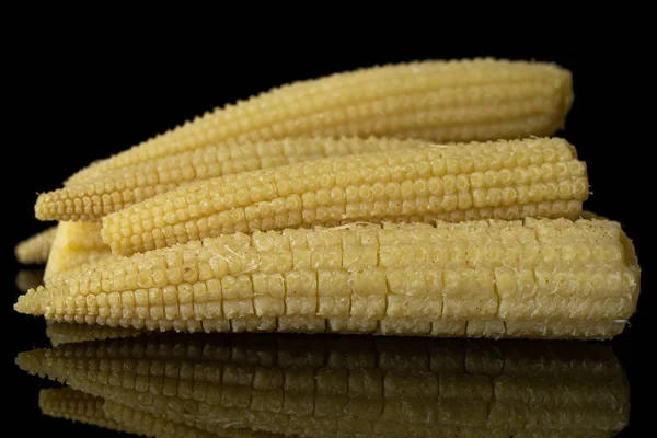 Pickled baby corn isolated on black glass — Stock Photo, Image