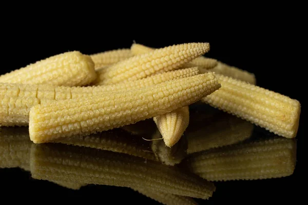 Pickled baby corn isolated on black glass — Stock Photo, Image