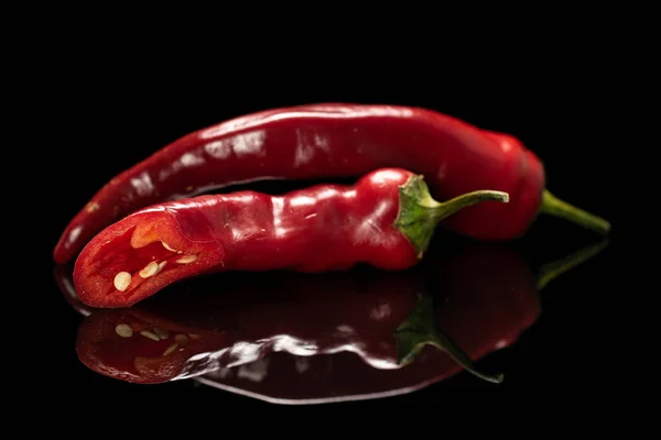 Fresh hot pepper isolated on black glass — Stock Photo, Image