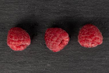 Gri taş üzerinde taze kırmızı ahududu