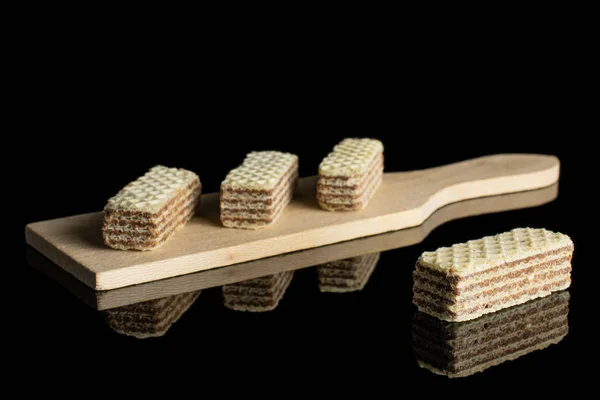 Hazelnut wafer cookie isolated on black glass — Stock Photo, Image