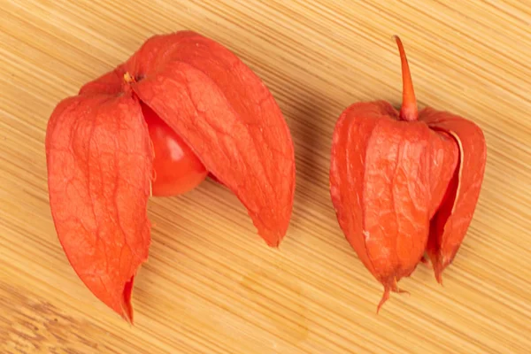 Fresh orange physalis on light wood — Stock Photo, Image