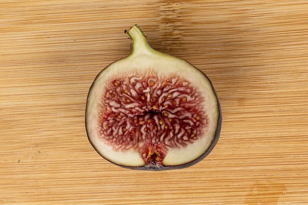 Sweet purple fig on light wood