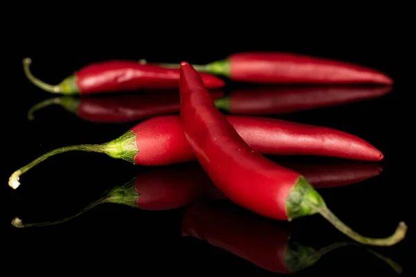 Red hot cayenne chili isolated on black glass — Stock Photo, Image