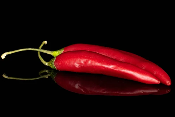 Red hot cayenne chili isolated on black glass — Stock Photo, Image