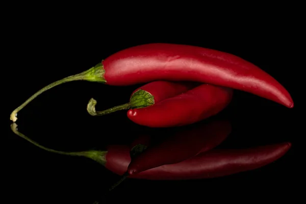 Red hot cayenne chili isolated on black glass — Stock Photo, Image