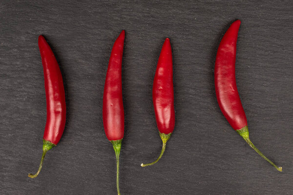 Red hot cayenne chili on grey stone