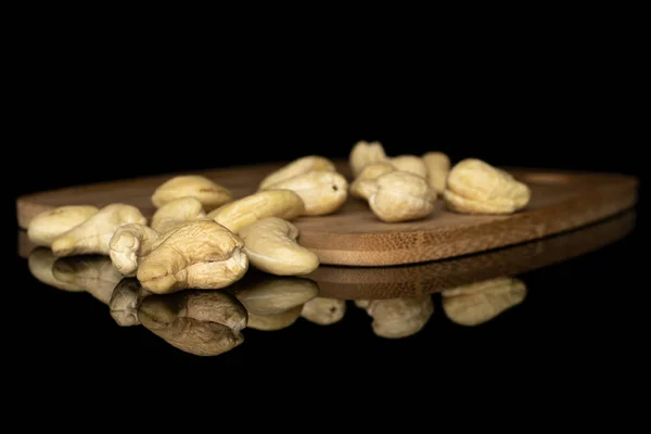 Fresh cashew nut isolated on black glass — Stock Photo, Image