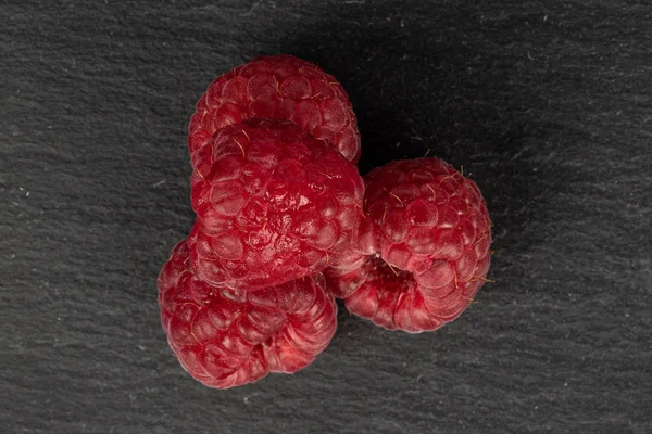 Fresh red raspberry on grey stone — Stock Photo, Image