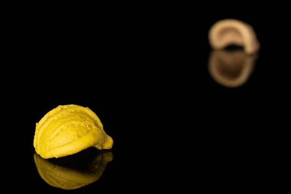 Pasta orecchiette isolated on black glass — Stock Photo, Image