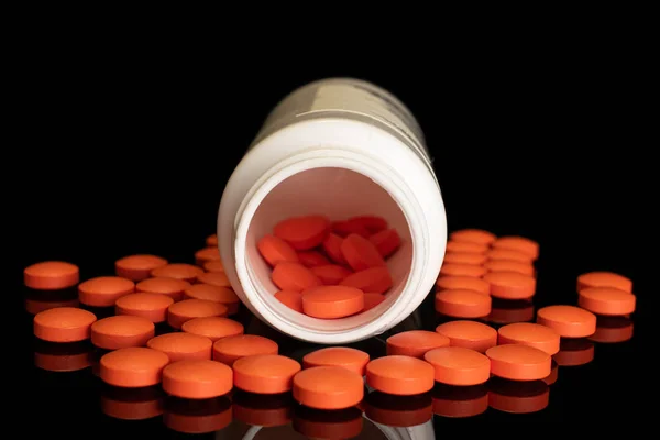 Oranje apotheek tablet geïsoleerd op zwart glas — Stockfoto