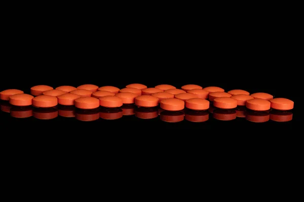 Siyah camlara izole edilmiş turuncu eczane tableti. — Stok fotoğraf