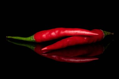 Hot bird's eye chili isolated on black glass clipart