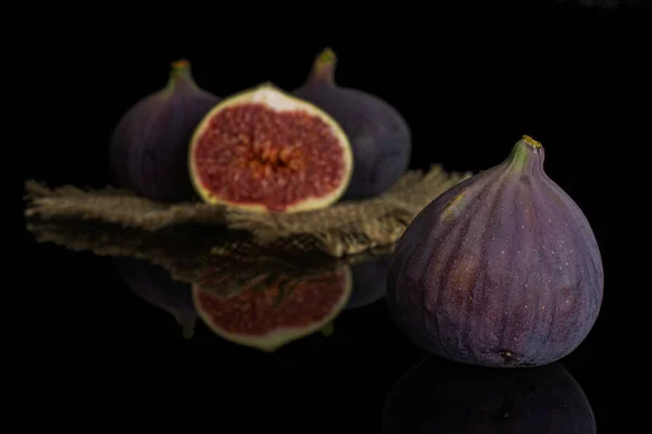 Fresh purple fig isolated on black glass — Stock Photo, Image
