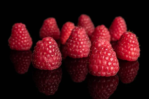 Fresh red raspberry isolated on black glass — Stock Photo, Image