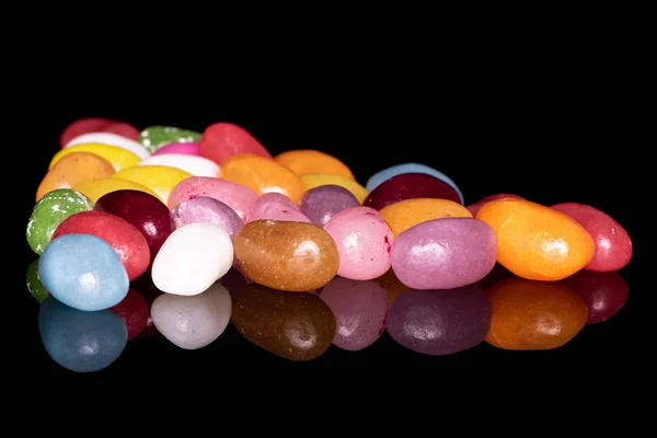 Jelly bean snoep geïsoleerd op zwart glas — Stockfoto