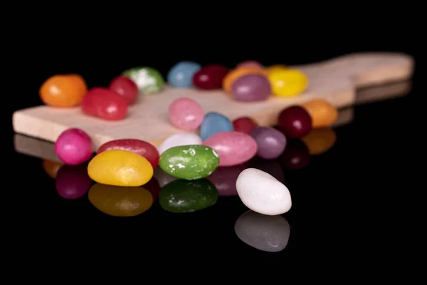 Jelly bean snoep geïsoleerd op zwart glas — Stockfoto