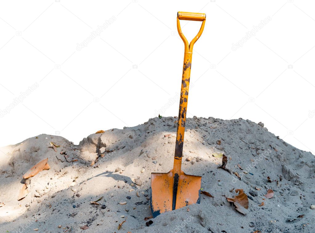 Old orange shovel On the pile of sand isolated on white background. With clipping path