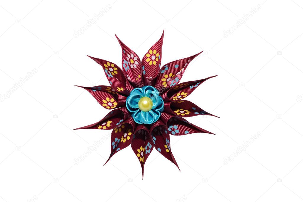 Kanzashi. Blue artificial flower on maroon star isolated on whit