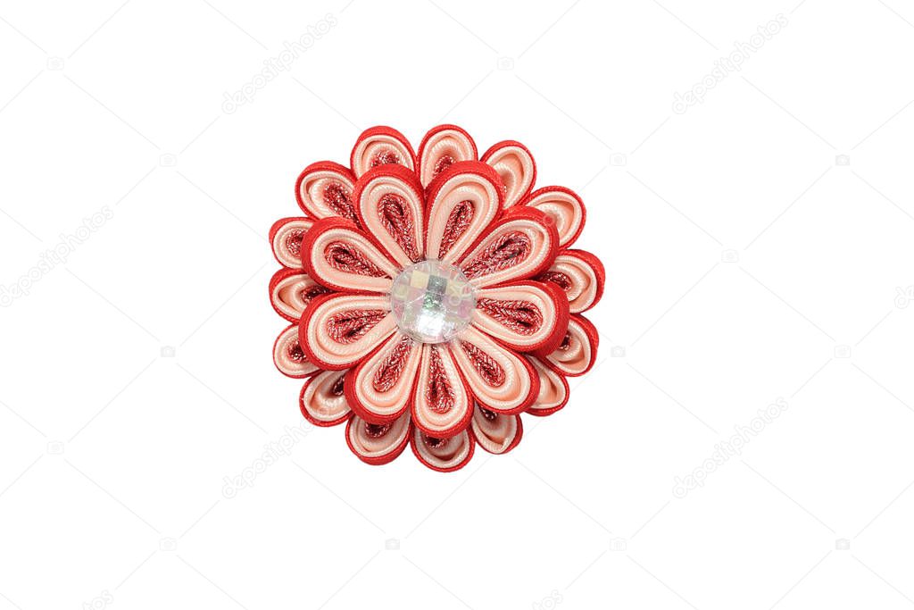 Kanzashi. Red artificial flower with brocade isolated on white b