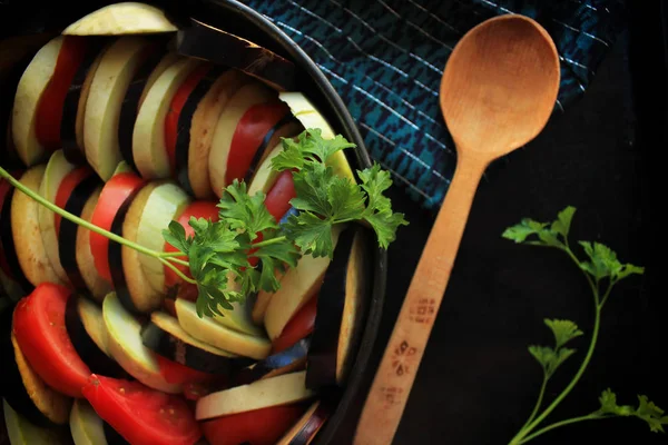 Ratatouille - vegetarian french dish made of zucchini, eggplants, peppers, onions, garlic and tomatoes with aromatic herbs. Traditional french food