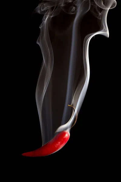 Red pepper pouring smoke on black background — Stock Photo, Image