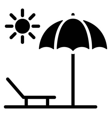 Sahilde bir şemsiye altında bir şezlong 
