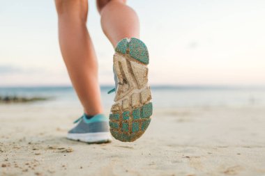 Kumsalda çalışan kadın jogger kadeh kırpılmış 