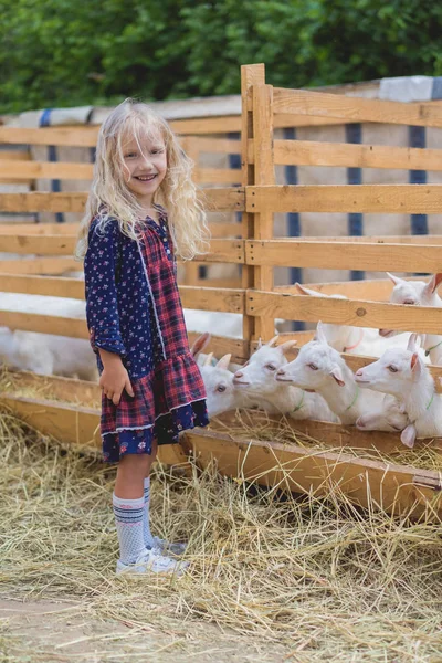 Happy Kid Standing Goats Farm Looking Camera — Free Stock Photo