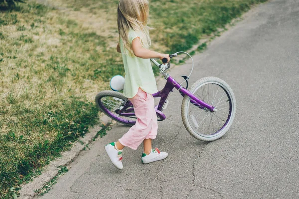 Side view of kid with bicycle on street — Stock Photo