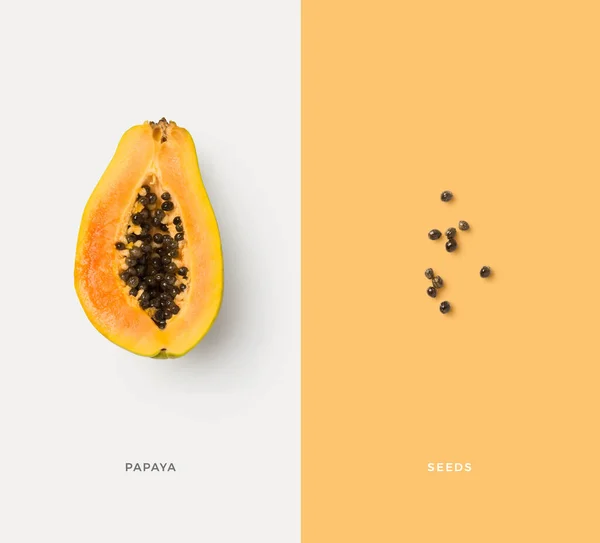 创意食物 饮食概念与五彩缤纷的孤立木瓜一半和种子 简约的彩色图形布局或背景 — 图库照片