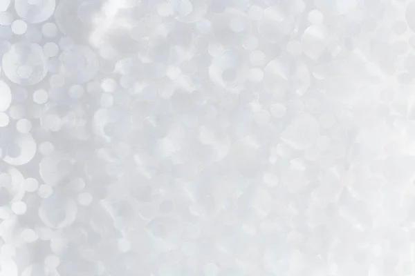 Farklı boyutlarda şeffaf dairelerin inci rengi arka planı. Hassas doku.