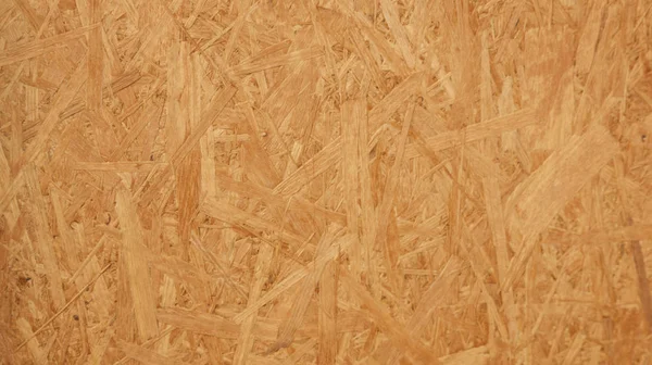 OSB board texture and background, made of brown wood chips sanded into a wooden chipboard. Close up view off MDF wood veneer. - Stock image Russia, Abstract, Beige, Brown, Built Structure