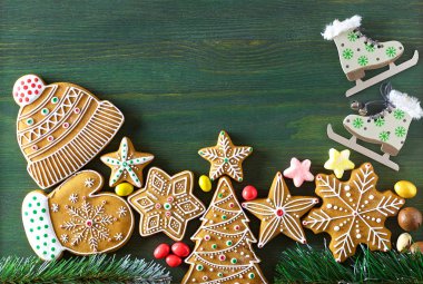 Noel zencefilli, farklı tatlılar, fındık ve süs ler ladin dalları ile yeşil renk ahşap bir masa üzerinde yalan