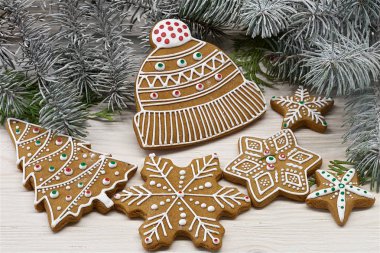 Beyaz ahşap arka plan üzerinde farklı Noel zencefilli kurabiye bir gruptur. Ağacın dalıarka. Renkli fotoğraf