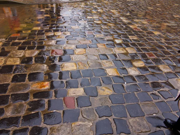 old cobblestone road in rainy weather