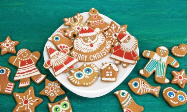 Beyaz tabakta zencefilli kurabiye ve yeşil arka plan