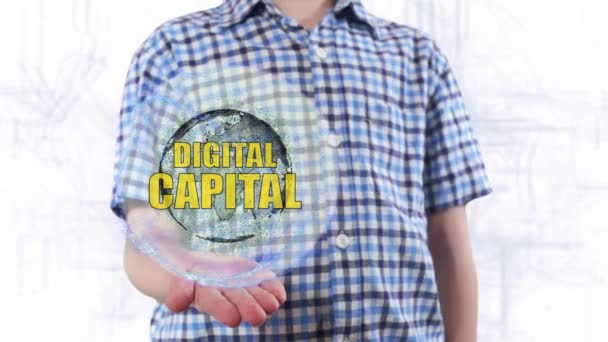 Giovane uomo mostra un ologramma del pianeta Terra e testo Capitale digitale — Video Stock