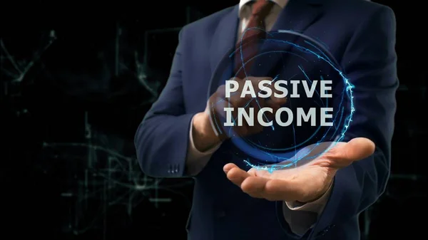 Businessman shows concept hologram Passive income on his hand — Stock Photo, Image