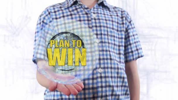 Young man shows a hologram of the planet Earth and text Plan to win — Stock Video